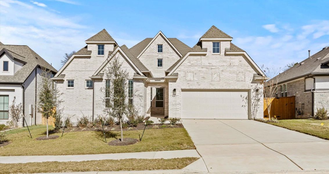 Front exterior of a new home in 6 Creeks, Kyle, TX, highlighting curb appeal (Image 1). Front exterior of a new home in 6 Creeks, Kyle, TX, highlighting curb appeal (Image 1).