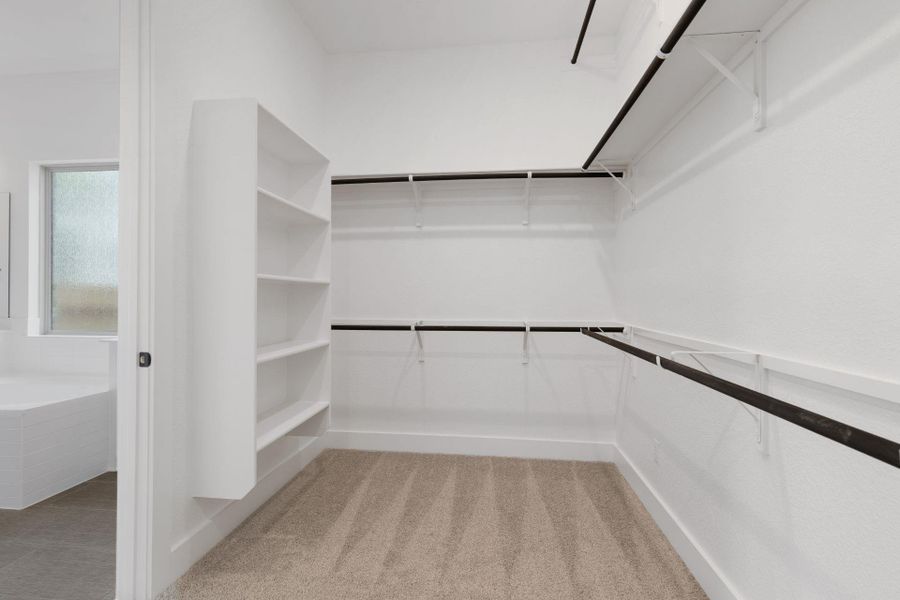 Walk-in closet in Primary Bedroom Walk-in closet in Primary Bedroom