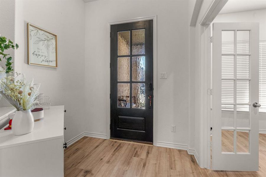 Foyer entrance with light hardwood / wood-style flooring