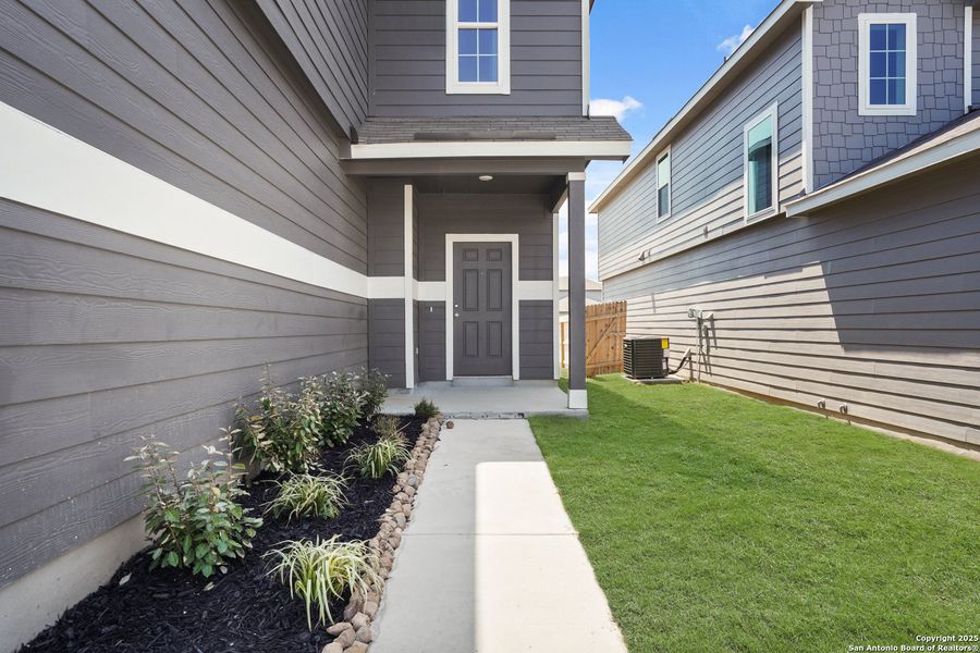 Front exterior of a new home in Abbott Place, St. Hedwig, TX, highlighting curb appeal (Image 17).
