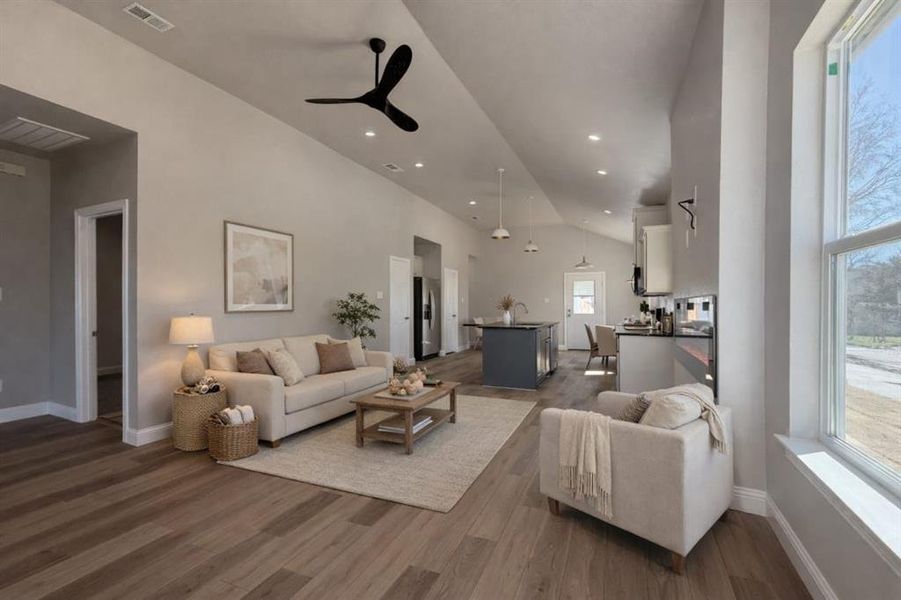 Living room featuring ceiling fan, dark wood-type flooring, lofted ceiling, and recessed lighting