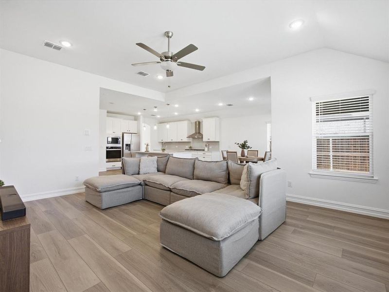 Living room view of single story three bedroom home with an office and a formal dining room