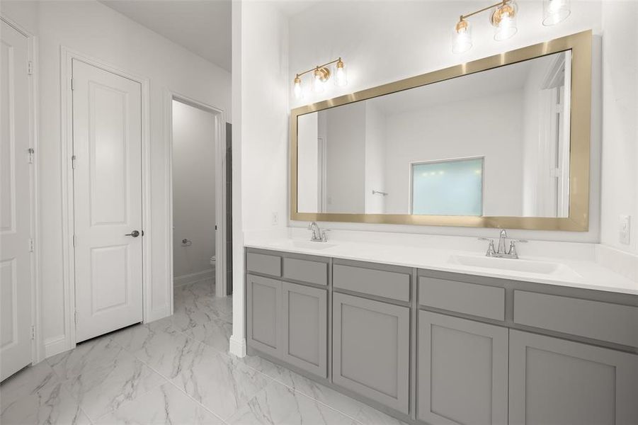Full bathroom featuring marble finish flooring and double vanity Full bathroom featuring marble finish flooring and double vanity
