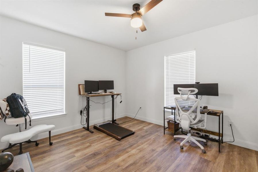Home office featuring wood finished floors and a ceiling fan Home office featuring wood finished floors and a ceiling fan