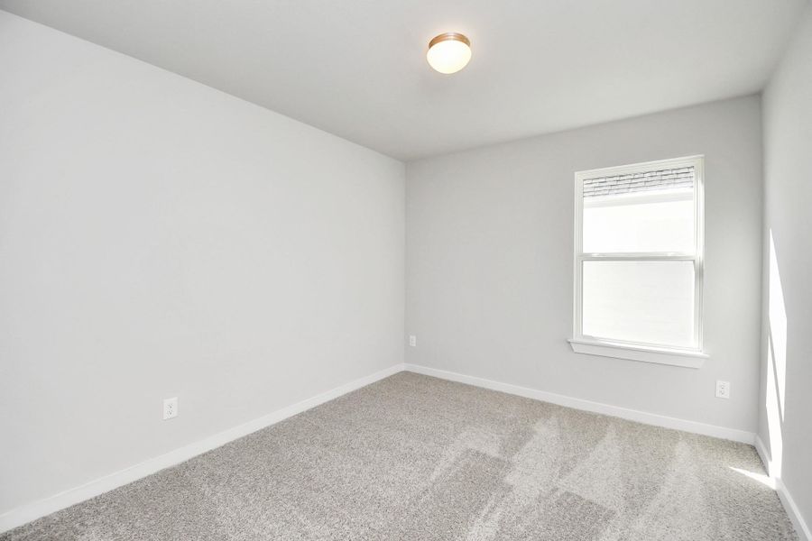 Discover another perspective of the secondary bedroom! Sample photo of completed home with similar floor plan. Actual colors and selections may vary.