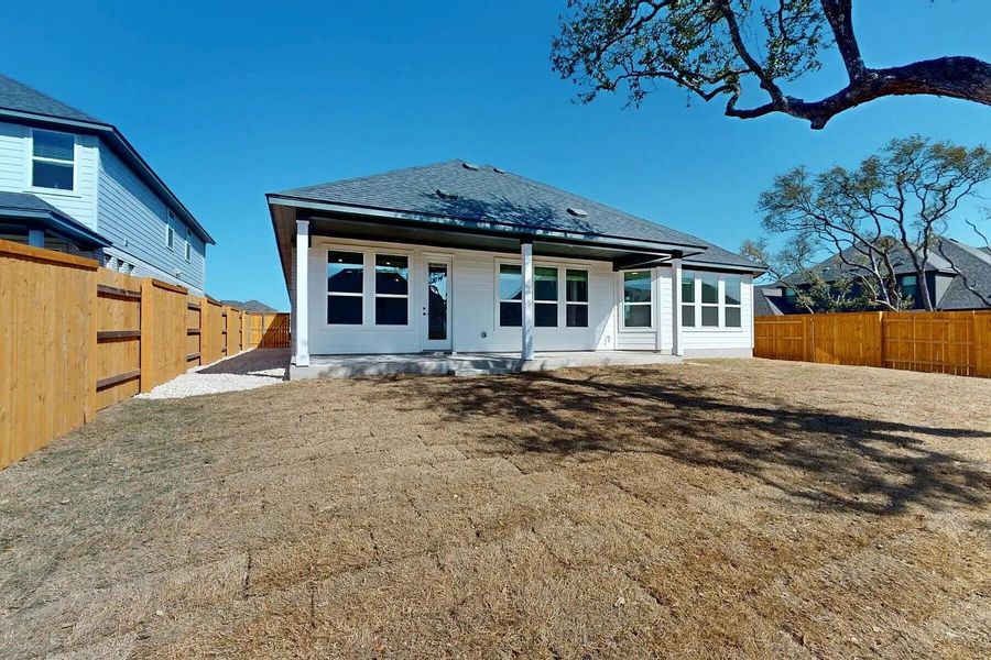 The property features a white exterior with a dark roof and a covered patio