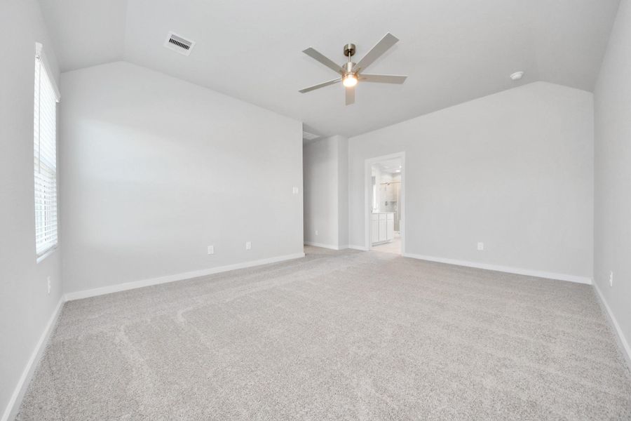 Come and unwind after a long day in this magnificent primary suite! This spacious room features plush carpet, warm paint, high ceilings and large windows with privacy blinds. Sample photo of completed home with similar floor plan. Actual colors and selections may vary. Come and unwind after a long day in this magnificent primary suite! This spacious room features plush carpet, warm paint, high ceilings and large windows with privacy blinds. Sample photo of completed home with similar floor plan. Actual colors and selections may vary.