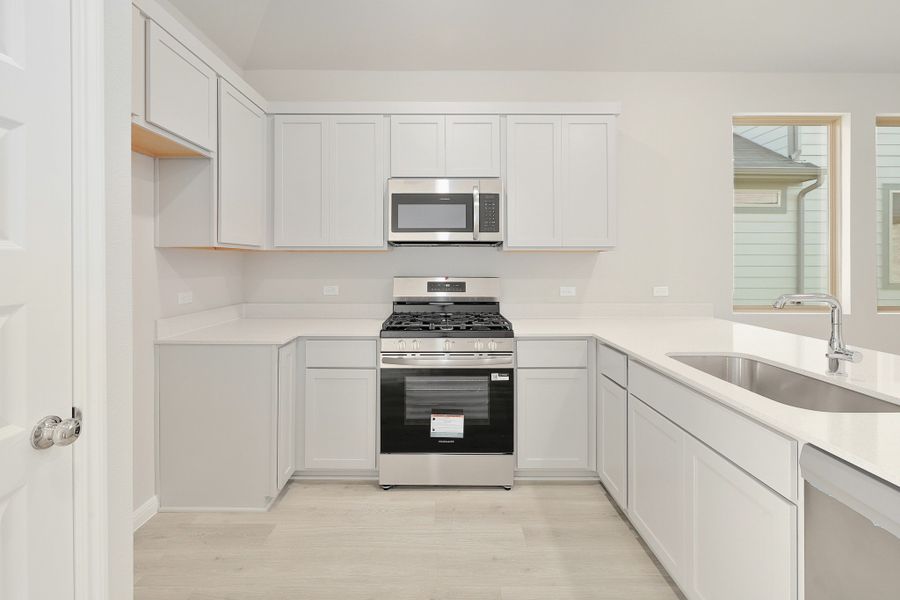 Kitchen in the Ash home plan by Trophy Signature Homes – REPRESENTATIVE PHOTO