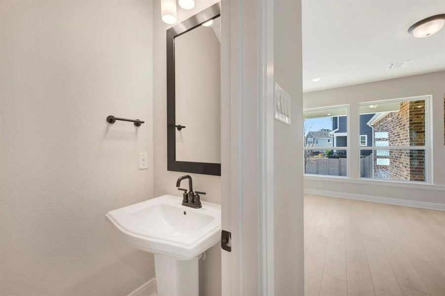 Bathroom featuring baseboards and light wood-style floors