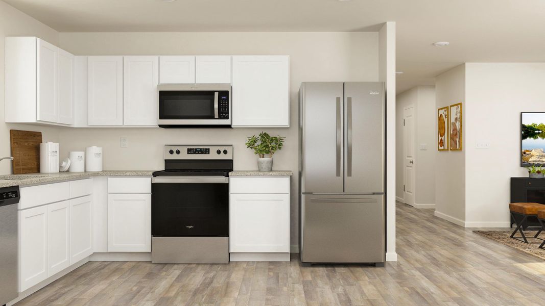 A kitchen with white cabinets.