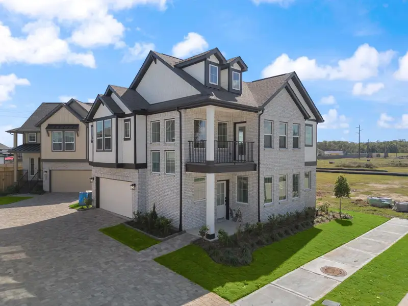 Front exterior of a new home in Sienna, Missouri City, TX, highlighting curb appeal (Image 2). Front exterior of a new home in Sienna, Missouri City, TX, highlighting curb appeal (Image 2).