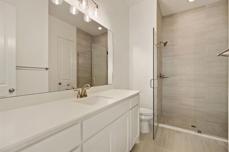 Bathroom with vanity, a stall shower, light tile patterned floors, and recessed lighting