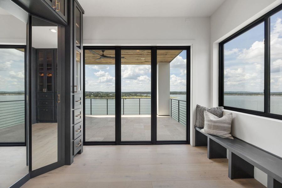 Unobstructed water views create a serene backdrop for daily living from this light-filled interior space. Unobstructed water views create a serene backdrop for daily living from this light-filled interior space.