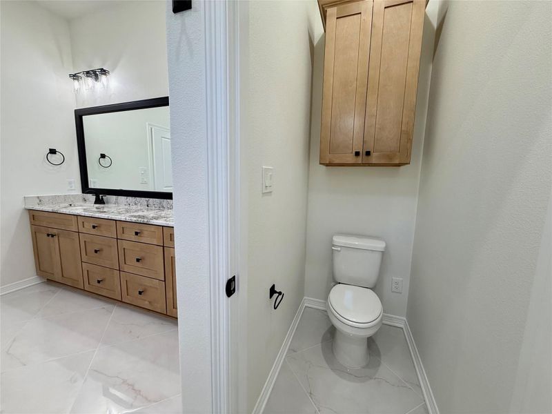 Bathroom featuring vanity and light marble finish floors