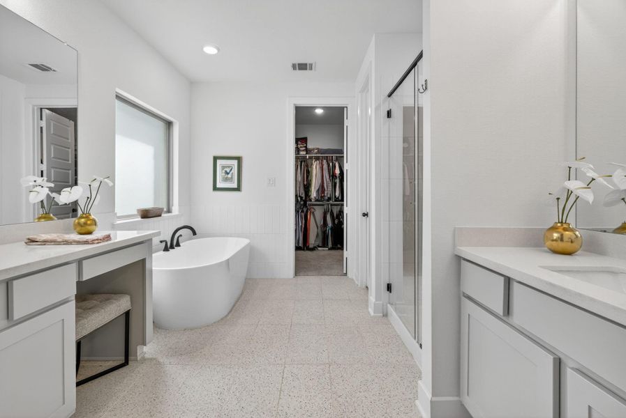 The Ensuite Primary Bath has quartz countertops, separate vanities, a soaking garden tub, walk-in shower and tile flooring! 31418 Golden Cliffs Ln., Fulshear, TX 77441 The Ensuite Primary Bath has quartz countertops, separate vanities, a soaking garden tub, walk-in shower and tile flooring! 31418 Golden Cliffs Ln., Fulshear, TX 77441