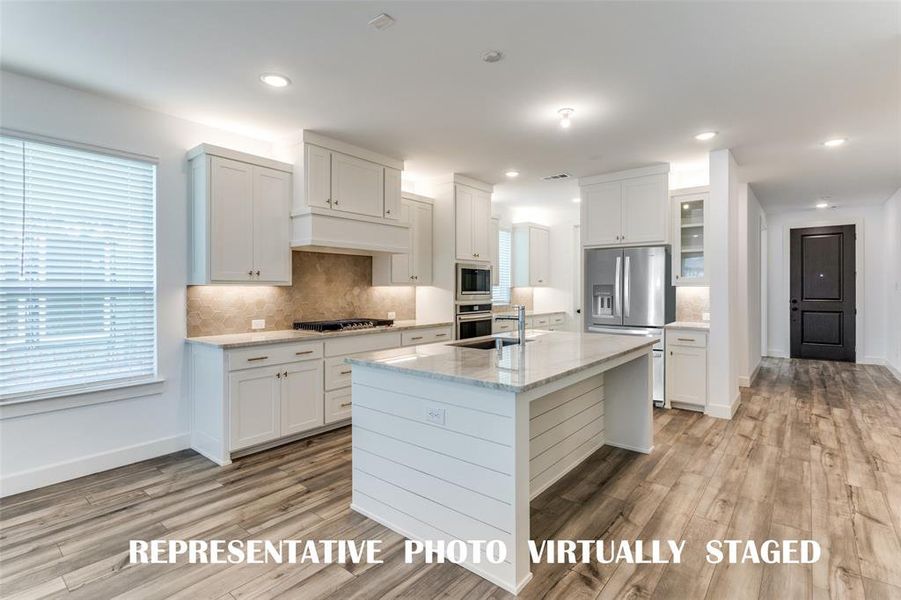 Our Juliet floor plan features a dream kitchen filled with tons of storage and prep space!  REPRESENTATIVE PHOTO VIRTUALLY STAGED.