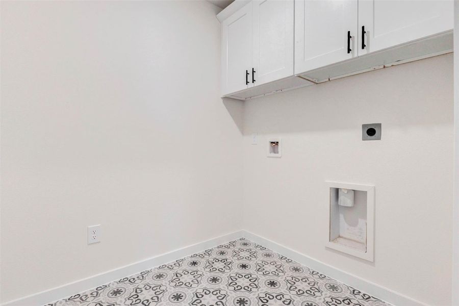 Style meets function in this dedicated laundry room, complete with decorative tile flooring, upper cabinetry for storage, and full utility connections. A clean and thoughtfully designed space that makes chores feel less like work. Style meets function in this dedicated laundry room, complete with decorative tile flooring, upper cabinetry for storage, and full utility connections. A clean and thoughtfully designed space that makes chores feel less like work.