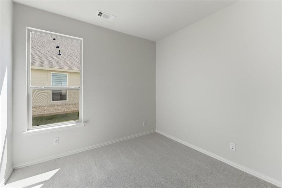 Carpeted empty room featuring baseboards