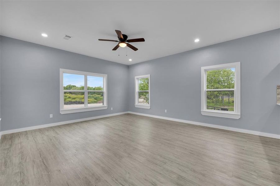 Empty room featuring ceiling fan, recessed lighting, and wood finished floors