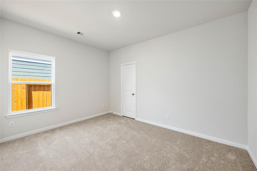 One of the two additional bedrooms in the home.