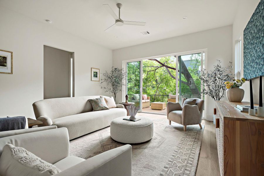 Living room featuring healthy amount of natural light, a ceiling fan, and wood finished floors
