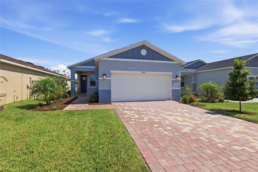Front exterior of a new home in Heron Bay, Palmetto, FL, highlighting curb appeal (Image 22). Front exterior of a new home in Heron Bay, Palmetto, FL, highlighting curb appeal (Image 22).