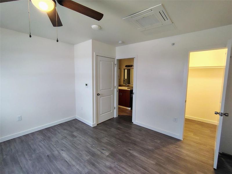 Spare room featuring ceiling fan, sink, and dark wood-type flooring