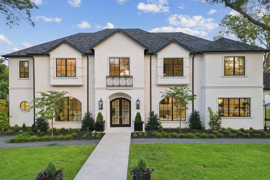 Warm drive up Preston Hollow home on large .73 acre lot.