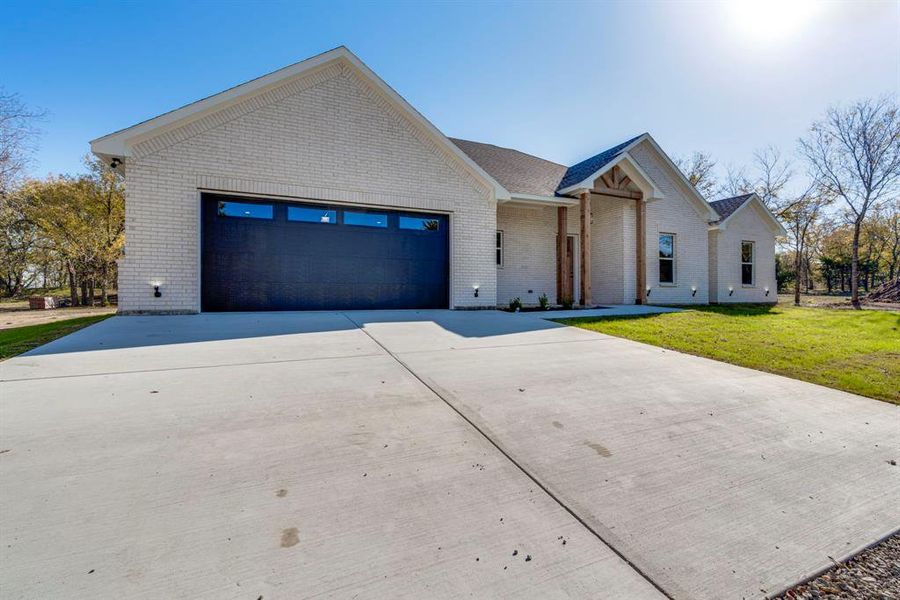 View of front of house with a front yard and a garage