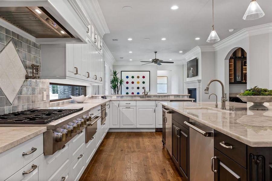 Kitchen with white cabinetry, backsplash, pendant lighting, and appliances with stainless steel finishes