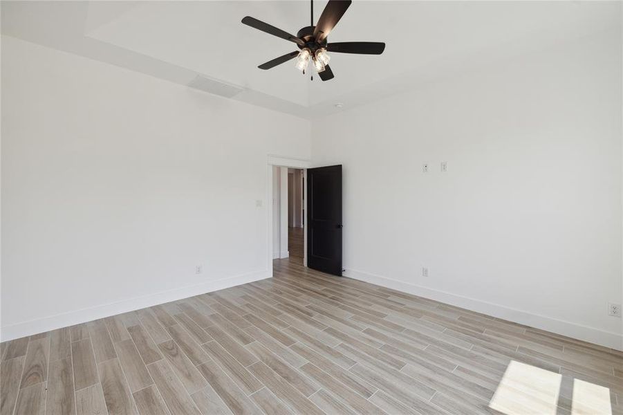 Unfurnished room with ceiling fan and light hardwood / wood-style flooring