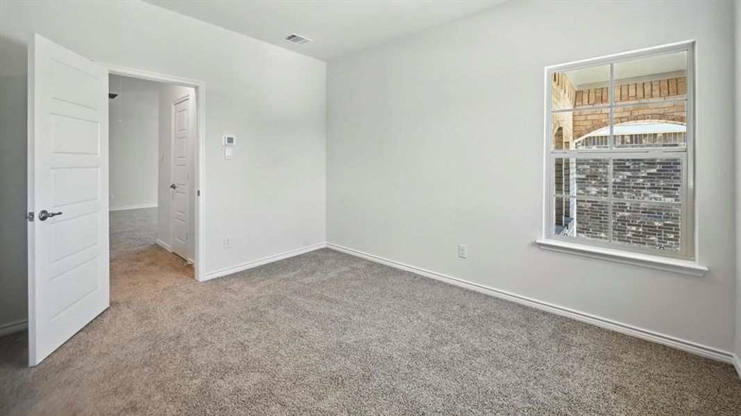Carpeted spare room with baseboards