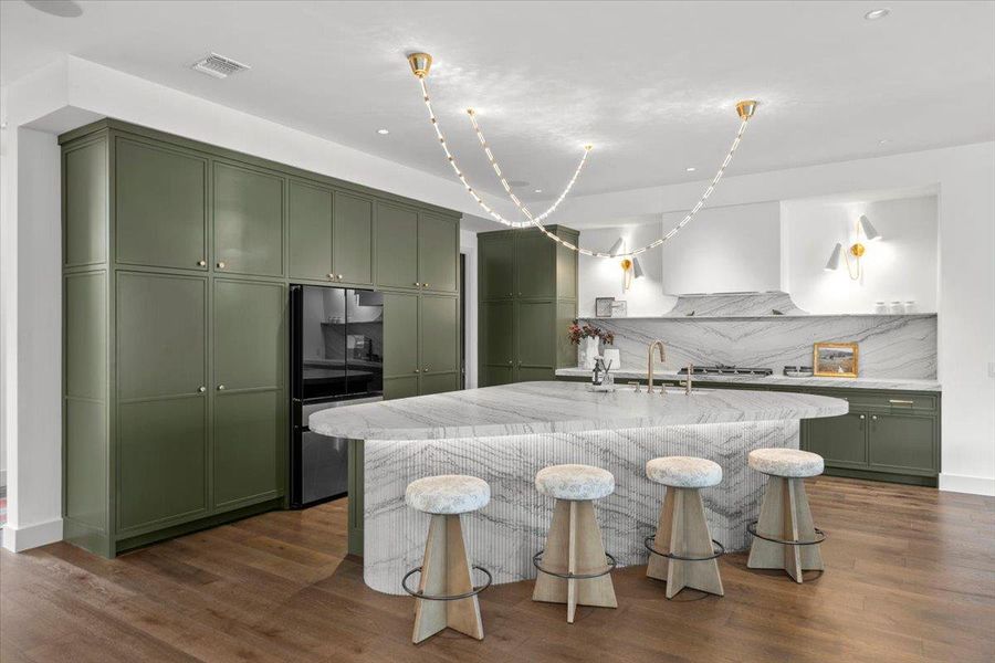 The sculptural kitchen island was inspired by a piano's curve.