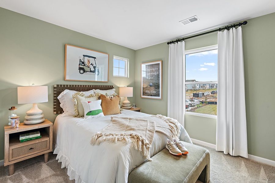 A bedroom with a large window.