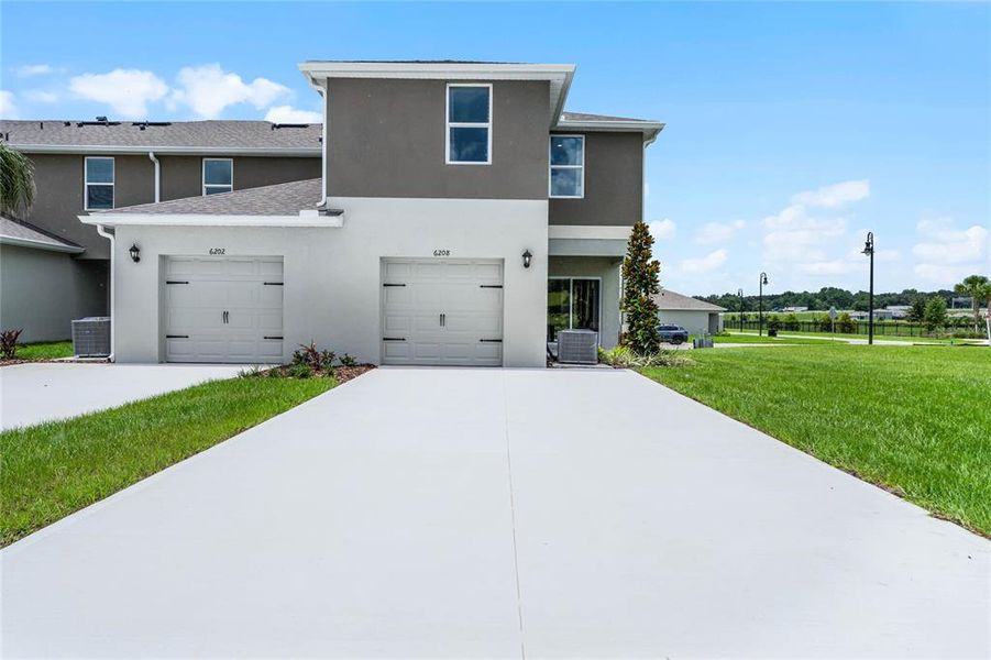 Front exterior of a new home in Windrose, Apopka, FL, highlighting curb appeal (Image 1).