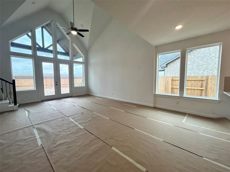 The open kitchen flows seamlessly into the family room, enhancing connectivity and ease of entertaining. A vaulted ceiling adds to the spacious feel, creating an airy and inviting atmosphere.