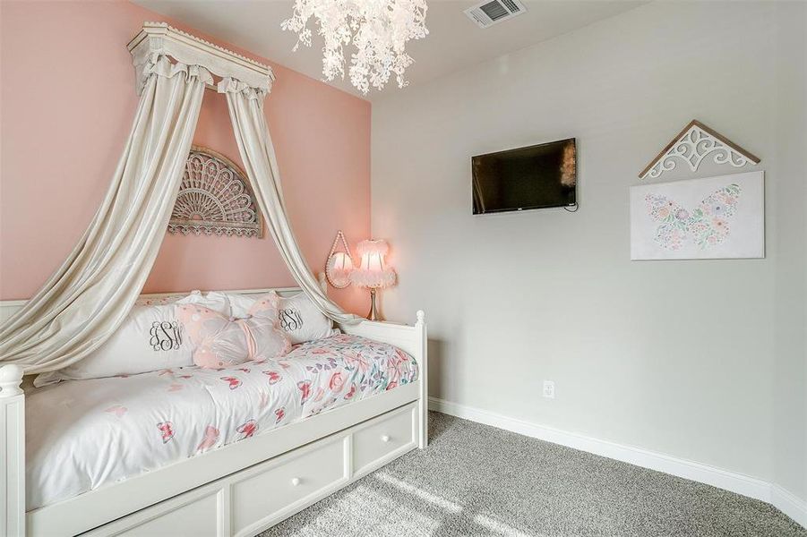 Carpeted bedroom featuring a chandelier, visible vents, and baseboards