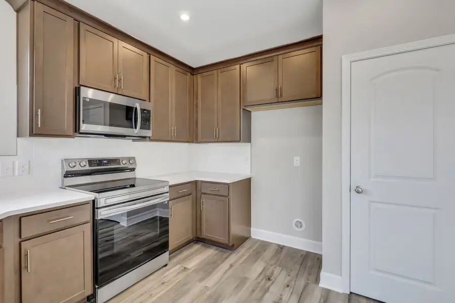 Rose Atoll Kitchen View with Built-in Microwave | Ernest Homes