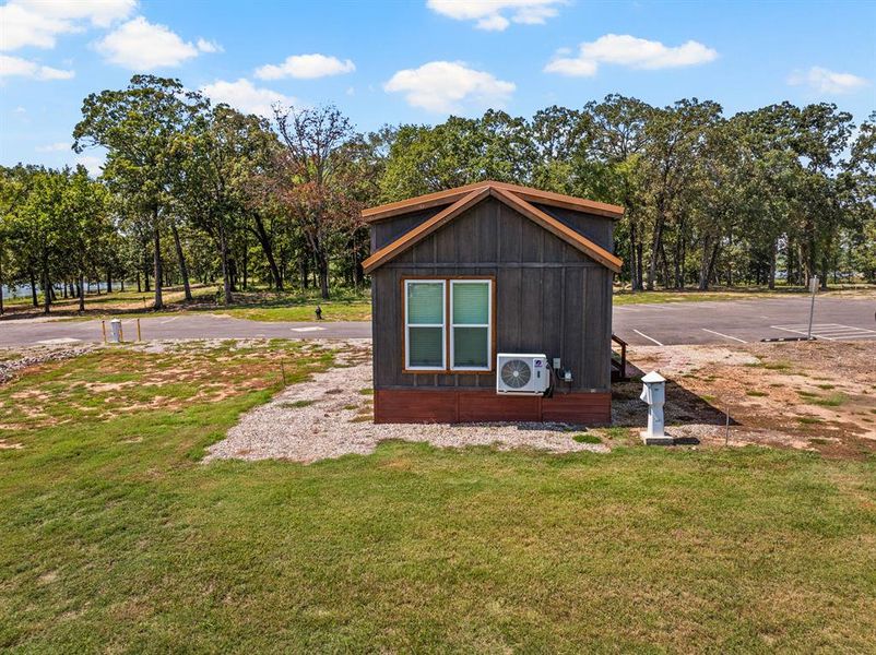 View of outbuilding with uncovered parking