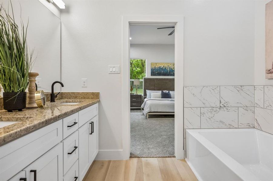 The ensuite primary bathroom features a large vanity with 2 sinks.