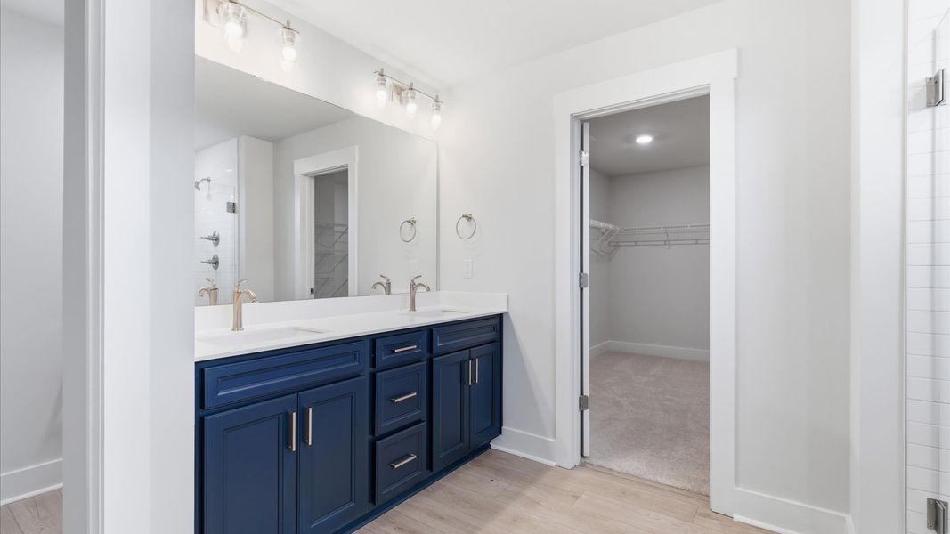 Spacious and modern primary bathroom with walk-in shower and first-class double vanity setup at this Foxbank home