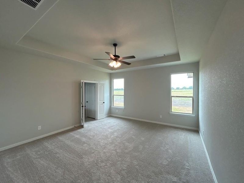 Spacious room featuring neutral carpeting and light-toned walls Spacious room featuring neutral carpeting and light-toned walls