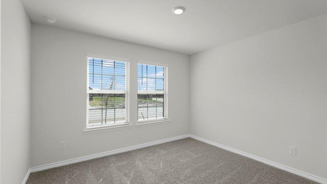 Room featuring two windows with horizontal blinds, neutral wall paint, gray carpet, white baseboards, and a recessed ceiling light