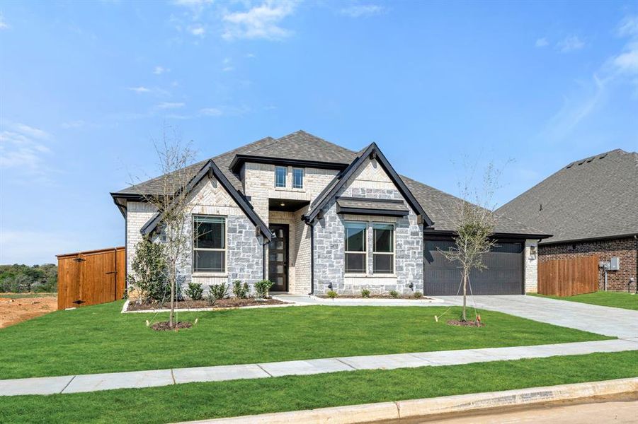 Front exterior of a new home in Mockingbird Hills, Joshua, TX, highlighting curb appeal (Image 2).
