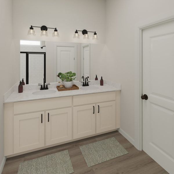 The primary's private ensuite offers dual sinks and tile shower, perfect for busy mornings.