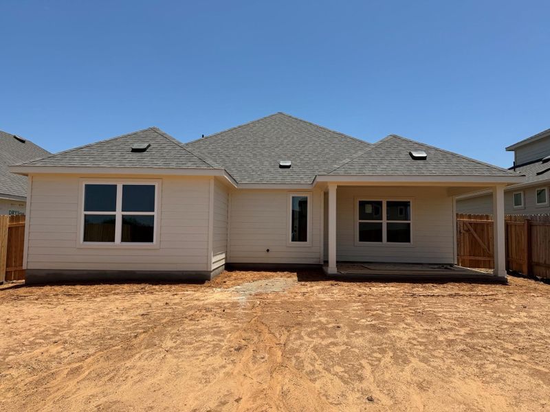 Rear view of house with a shingled roof Rear view of house with a shingled roof