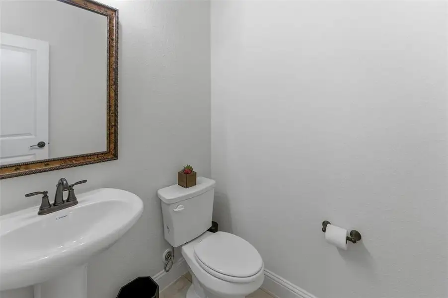 Bathroom with toilet and baseboards