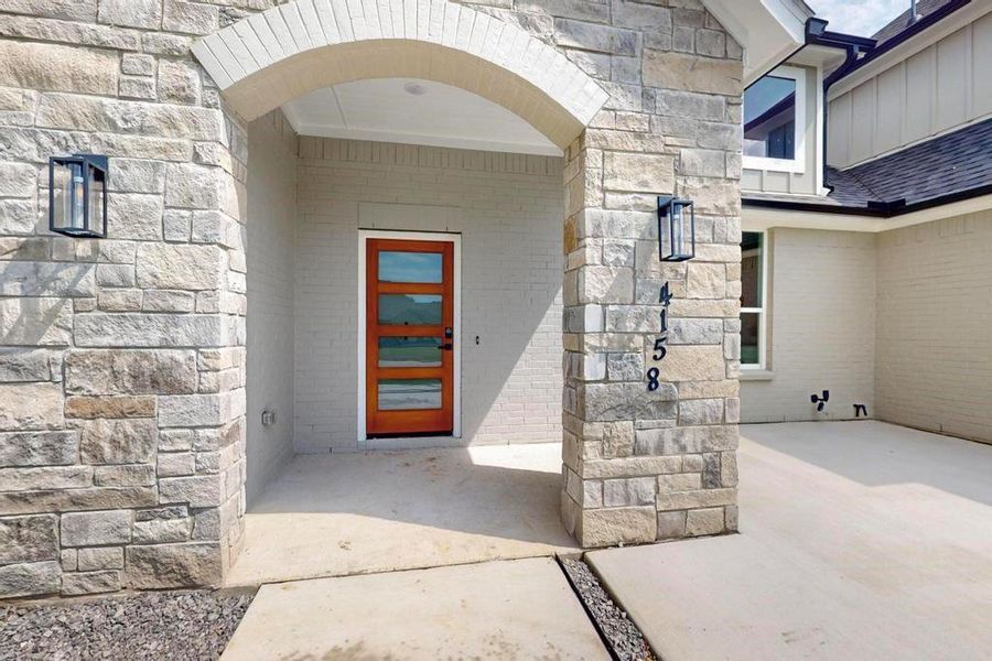 Doorway to property featuring stone siding