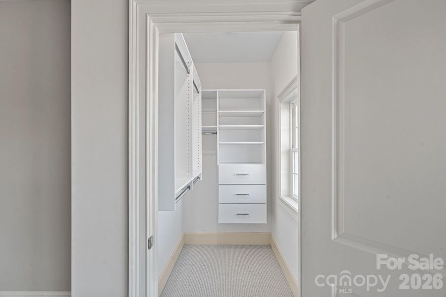 Custom closet with solid shelving in the Guest Suite.