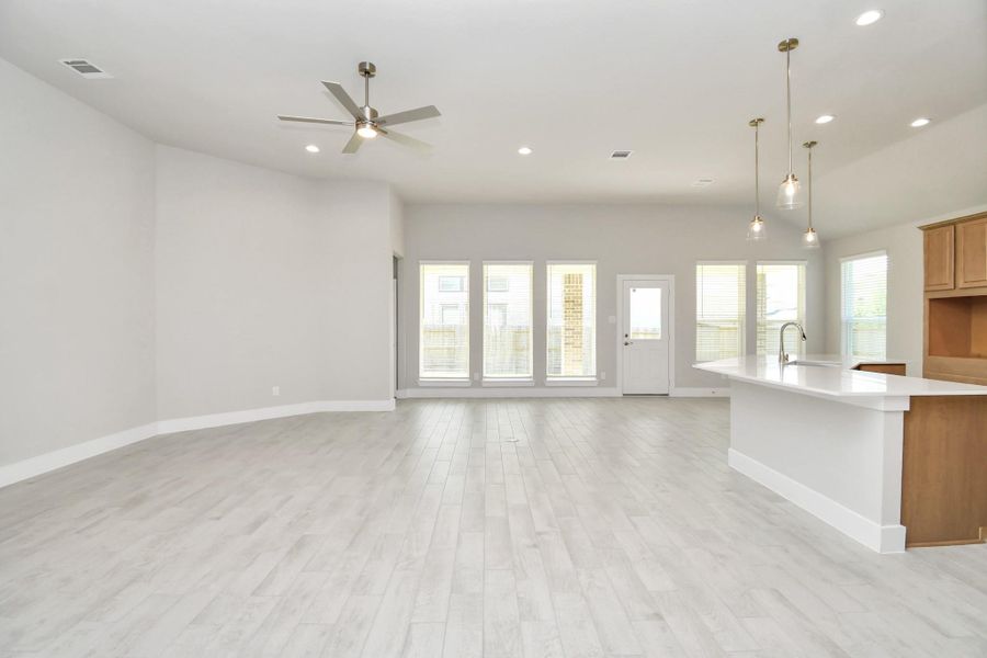 Gather the family and guests together in your lovely living room! Featuring soaring high ceilings, recessed lighting, ceiling fan, custom paint, gorgeous floors, and large windows that provide plenty of natural lighting throughout the day. Gather the family and guests together in your lovely living room! Featuring soaring high ceilings, recessed lighting, ceiling fan, custom paint, gorgeous floors, and large windows that provide plenty of natural lighting throughout the day.